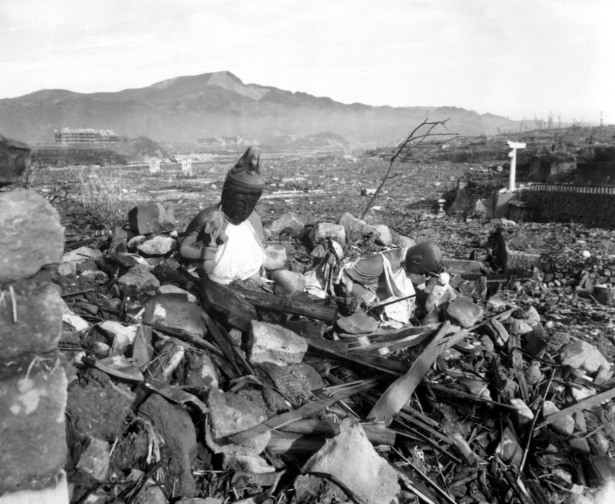 Battered religious figures stand watch on a hill above a tattered valley. Nagasaki, Japan. September 24, 1945. Cpl. Lynn P. Walker, Jr. (Marine Corps) NARA FILE #: 127-N-136176 WAR & CONFLICT BOOK #: 1241