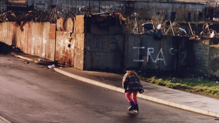 West Belfast, Northern Ireland, UK; March, 1994; Roller skater on the Catholic side of the Belfast Peace wall.