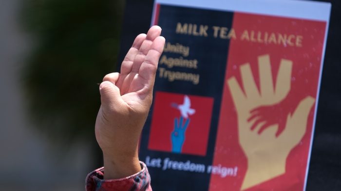 A demonstrator shows a three-fingered sign of resistance in a rally ÒTo End Dictatorship, Unity Against TyrannyÓ held by Mike Tea Alliance, Saturday, May 8, 2021 in Los Angeles.