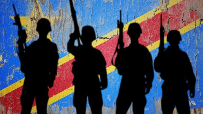 Flag of Congo Democratic painted on the cracked wall with soldier shadow.