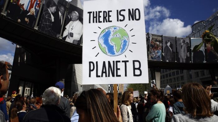 Brussels, Belgium. 8th Sep. 2018.Activists hold placards and chant slogans during a demonstration to demand immediate an action on climate change in front of European Parliament.