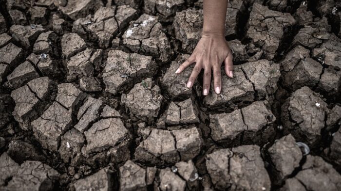 Hands on dry ground,Global warming and water crisis