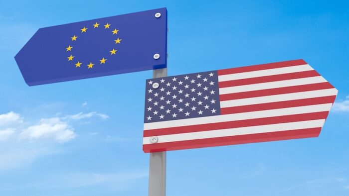 Disagreement: US And EU Road Sign Pointing In Different Directions Against A Cloudy Sky, 3d illustration