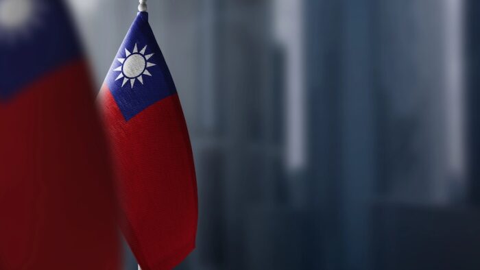 Small flags of Taiwan on a blurry background of the city.