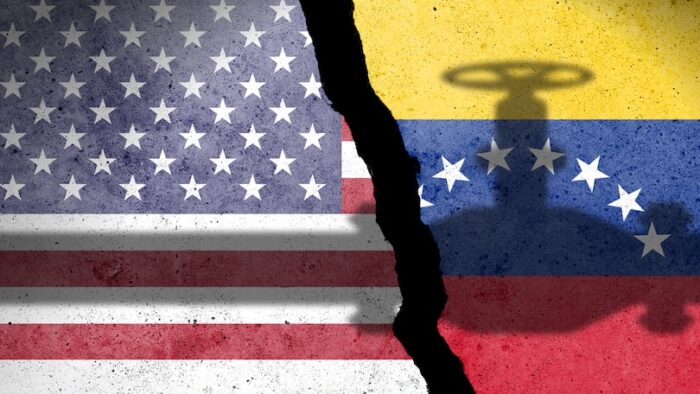 Flag of USA and Venezuela painted on a concrete wall with crude oil pipe shadow